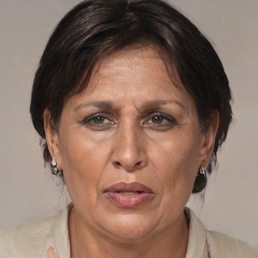 Joyful latino adult female with medium  brown hair and brown eyes