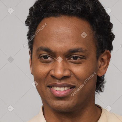 Joyful black young-adult male with short  brown hair and brown eyes