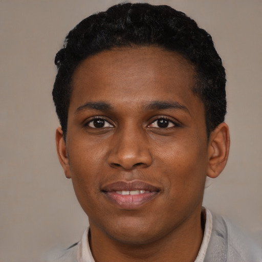 Joyful black young-adult male with short  black hair and brown eyes