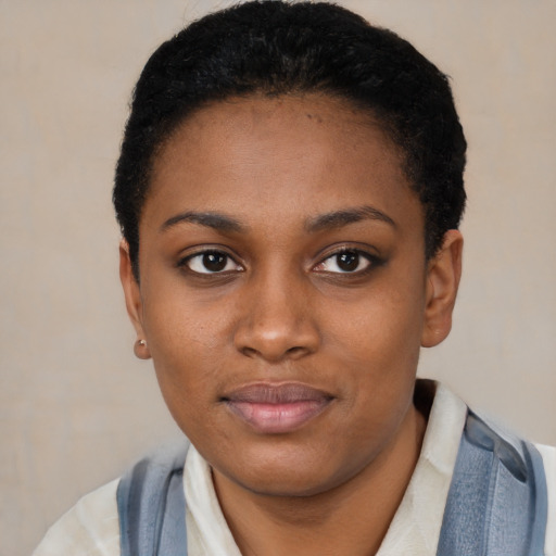 Joyful black young-adult female with short  black hair and brown eyes