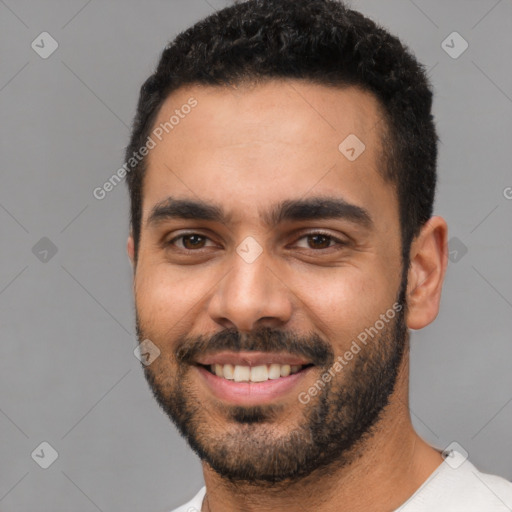 Joyful latino young-adult male with short  black hair and brown eyes