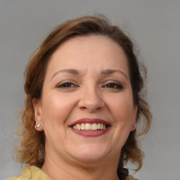 Joyful white adult female with medium  brown hair and brown eyes