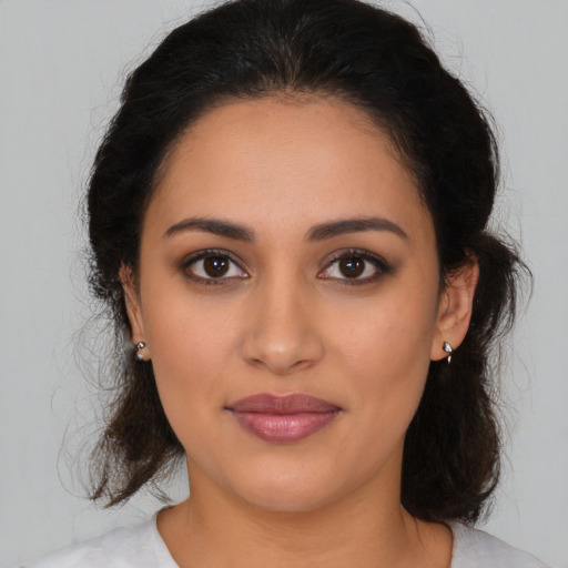 Joyful latino young-adult female with medium  brown hair and brown eyes