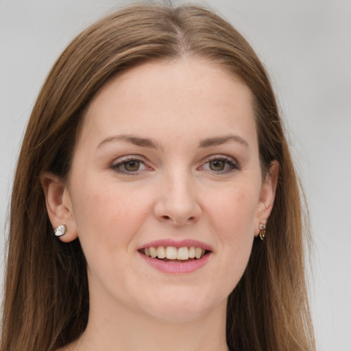 Joyful white young-adult female with long  brown hair and grey eyes