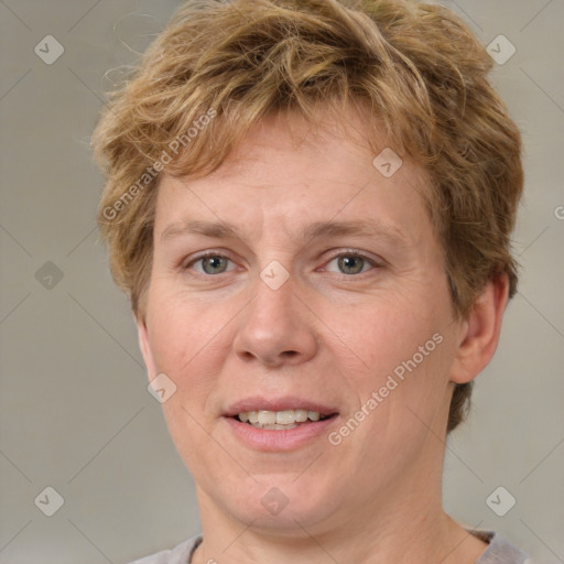 Joyful white adult female with short  brown hair and grey eyes