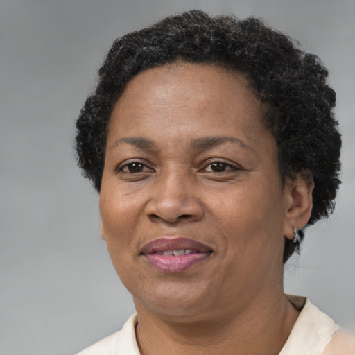 Joyful black adult female with short  brown hair and brown eyes