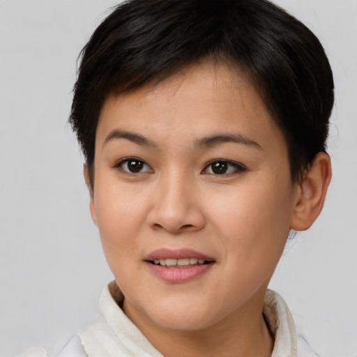Joyful asian young-adult female with short  brown hair and brown eyes