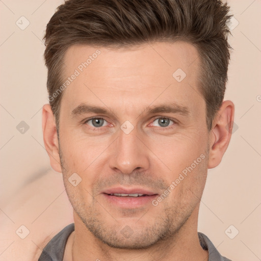 Joyful white adult male with short  brown hair and brown eyes