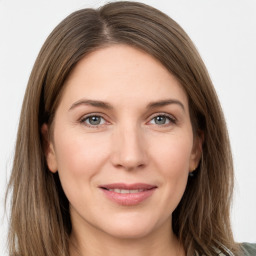 Joyful white young-adult female with long  brown hair and grey eyes