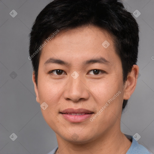 Joyful asian young-adult male with short  brown hair and brown eyes