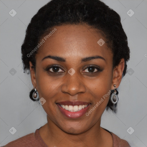 Joyful black young-adult female with short  black hair and brown eyes