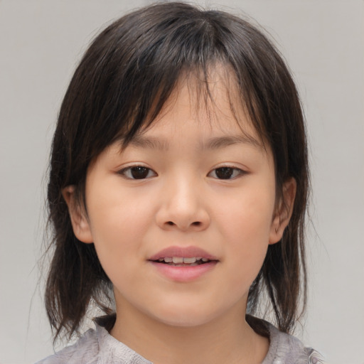 Joyful asian child female with medium  brown hair and brown eyes