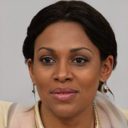 Joyful black adult female with medium  brown hair and brown eyes