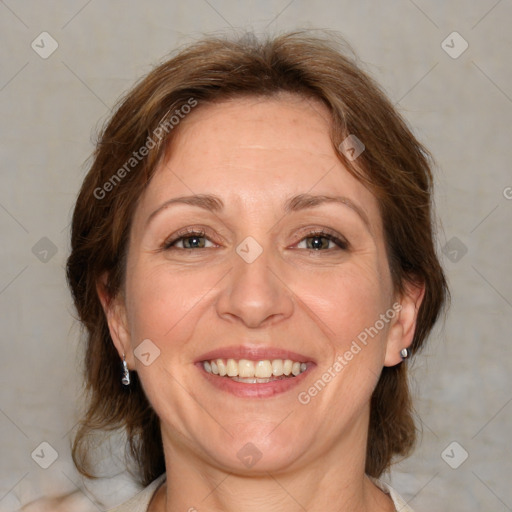 Joyful white adult female with medium  brown hair and blue eyes