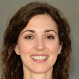 Joyful white young-adult female with long  brown hair and green eyes