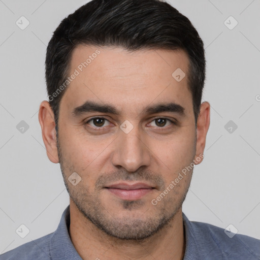 Joyful white young-adult male with short  black hair and brown eyes