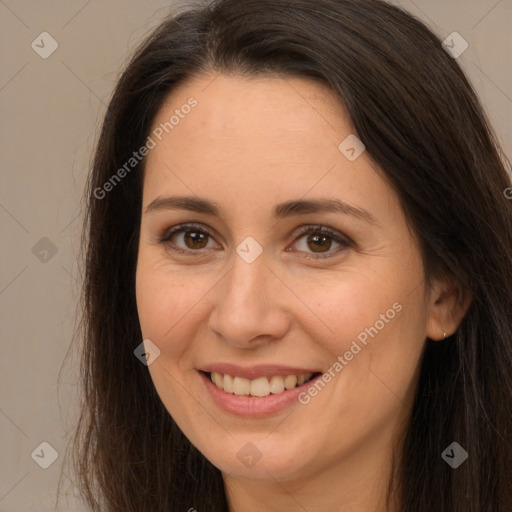 Joyful white adult female with long  brown hair and brown eyes