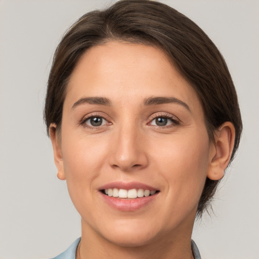 Joyful white young-adult female with medium  brown hair and brown eyes