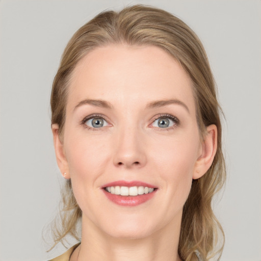 Joyful white young-adult female with medium  brown hair and blue eyes