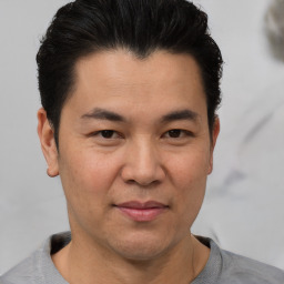 Joyful white adult male with short  black hair and brown eyes