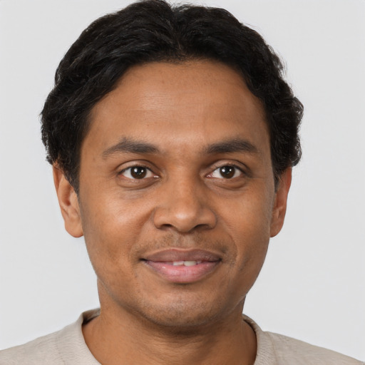 Joyful black adult male with short  brown hair and brown eyes