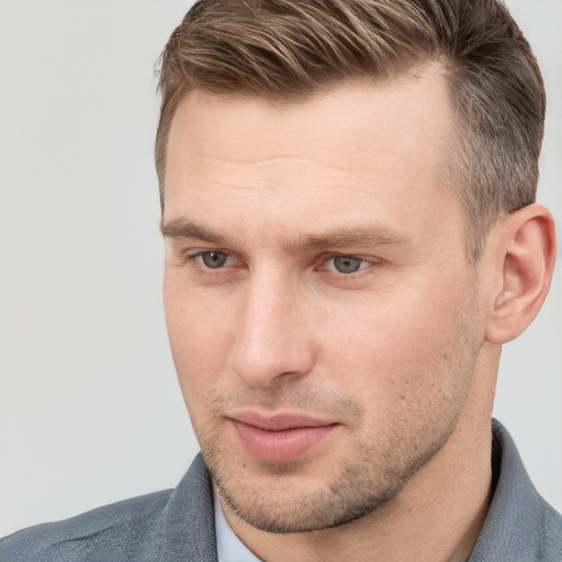 Joyful white adult male with short  brown hair and grey eyes