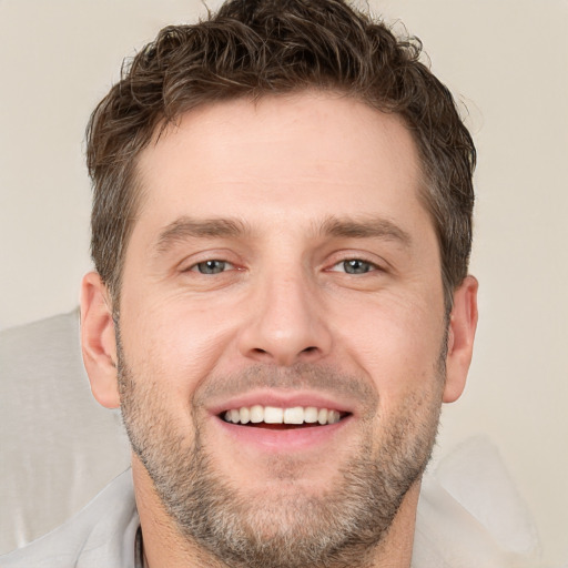 Joyful white young-adult male with short  brown hair and brown eyes