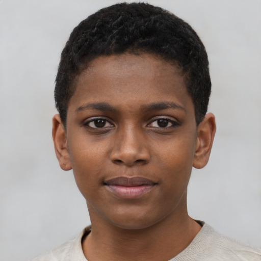 Joyful black child male with short  black hair and brown eyes