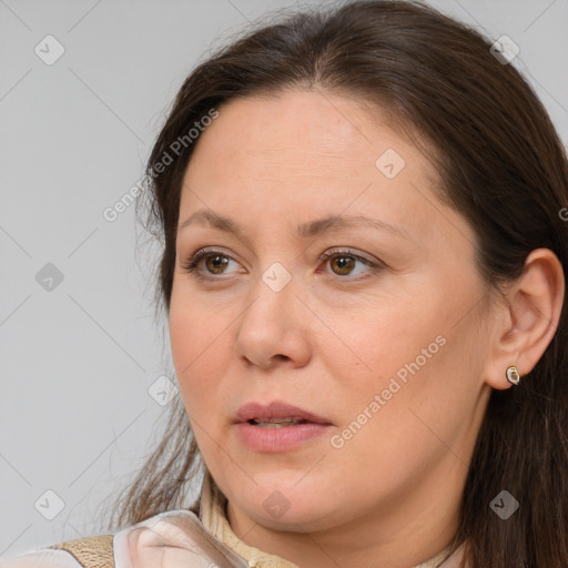 Joyful white adult female with long  brown hair and brown eyes