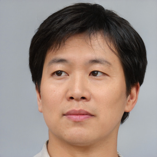 Neutral asian adult male with short  brown hair and brown eyes