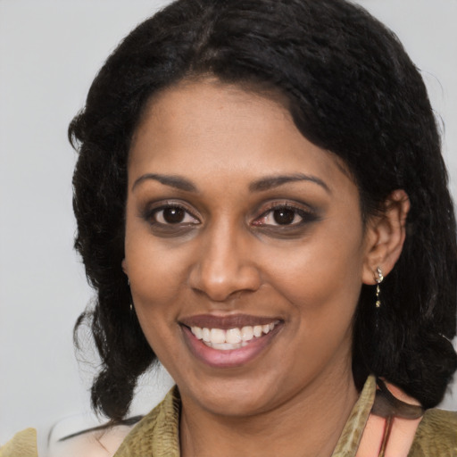 Joyful black young-adult female with medium  brown hair and brown eyes