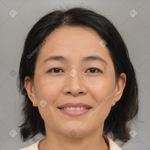 Joyful asian adult female with medium  brown hair and brown eyes