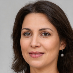 Joyful white adult female with long  brown hair and brown eyes