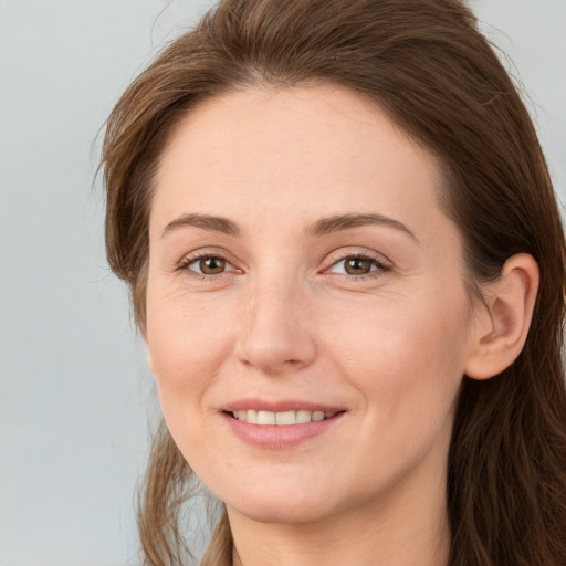 Joyful white young-adult female with long  brown hair and grey eyes