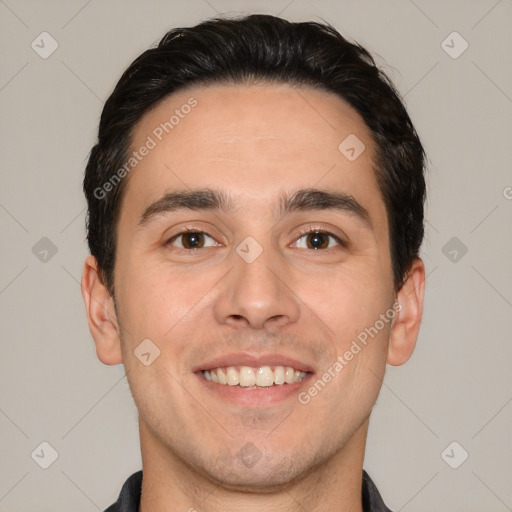 Joyful white young-adult male with short  black hair and brown eyes