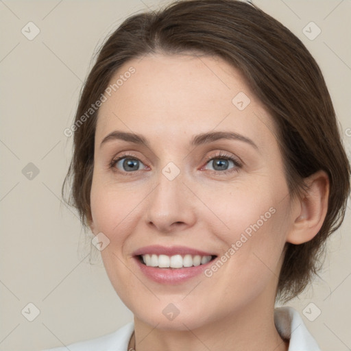 Joyful white young-adult female with medium  brown hair and grey eyes