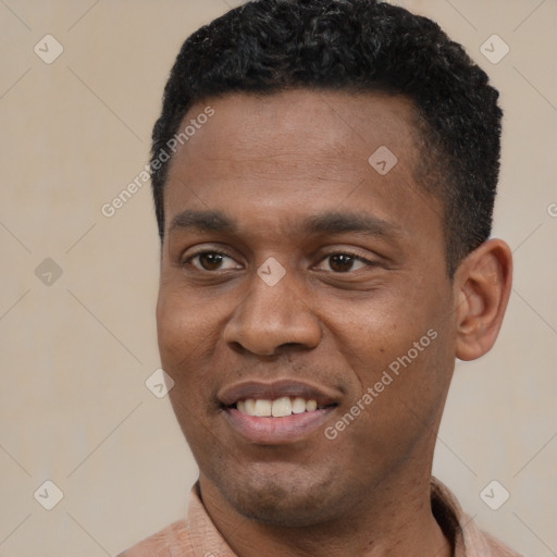 Joyful black young-adult male with short  black hair and brown eyes