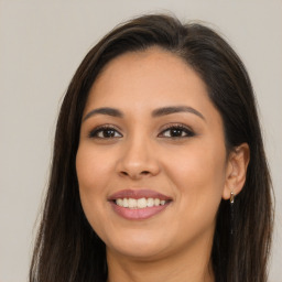 Joyful latino young-adult female with long  brown hair and brown eyes