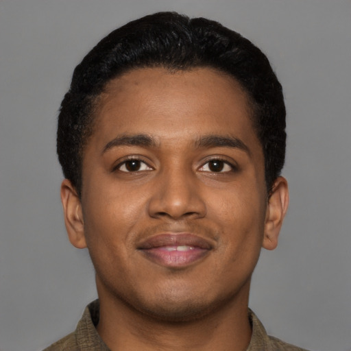 Joyful black young-adult male with short  brown hair and brown eyes