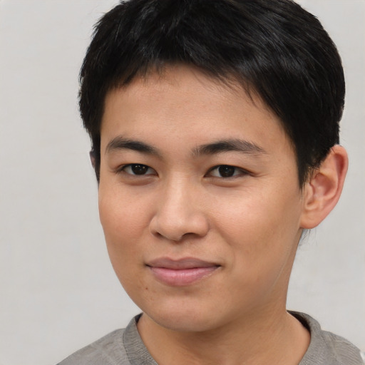 Joyful asian young-adult female with short  brown hair and brown eyes