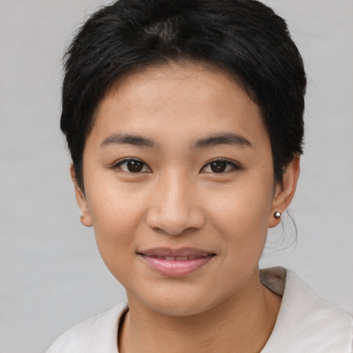 Joyful asian young-adult female with short  brown hair and brown eyes