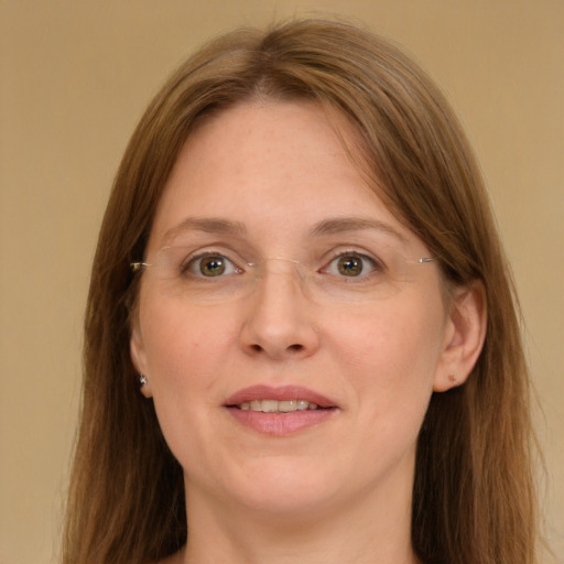 Joyful white adult female with long  brown hair and grey eyes