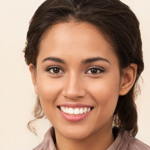 Joyful white young-adult female with long  brown hair and brown eyes