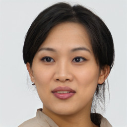 Joyful asian young-adult female with medium  black hair and brown eyes