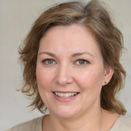 Joyful white young-adult female with medium  brown hair and green eyes