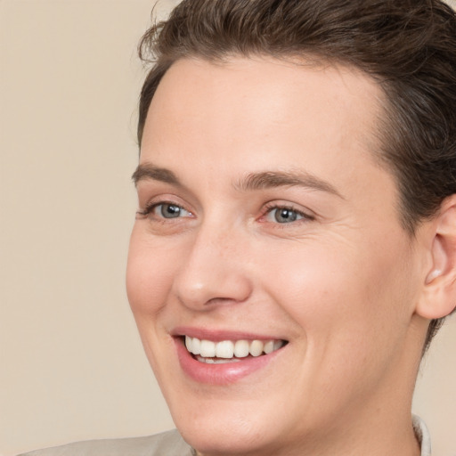 Joyful white young-adult female with medium  brown hair and brown eyes