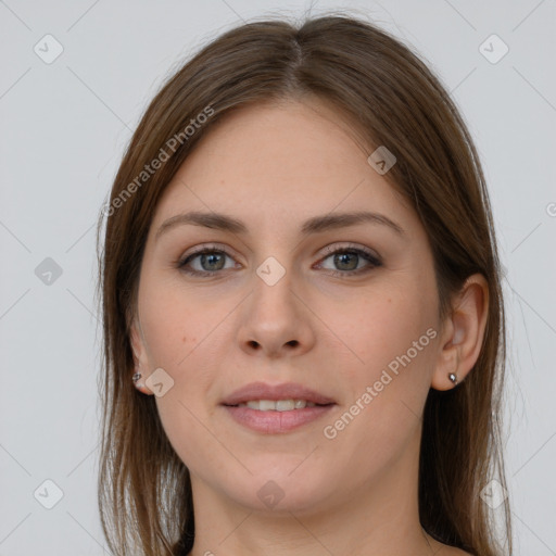 Joyful white young-adult female with long  brown hair and grey eyes