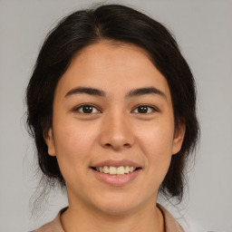 Joyful latino young-adult female with medium  brown hair and brown eyes