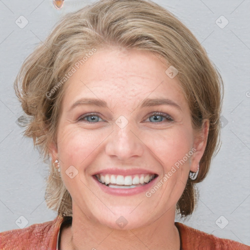 Joyful white adult female with medium  brown hair and blue eyes