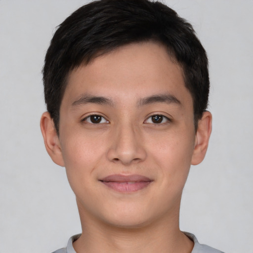 Joyful asian young-adult male with short  brown hair and brown eyes